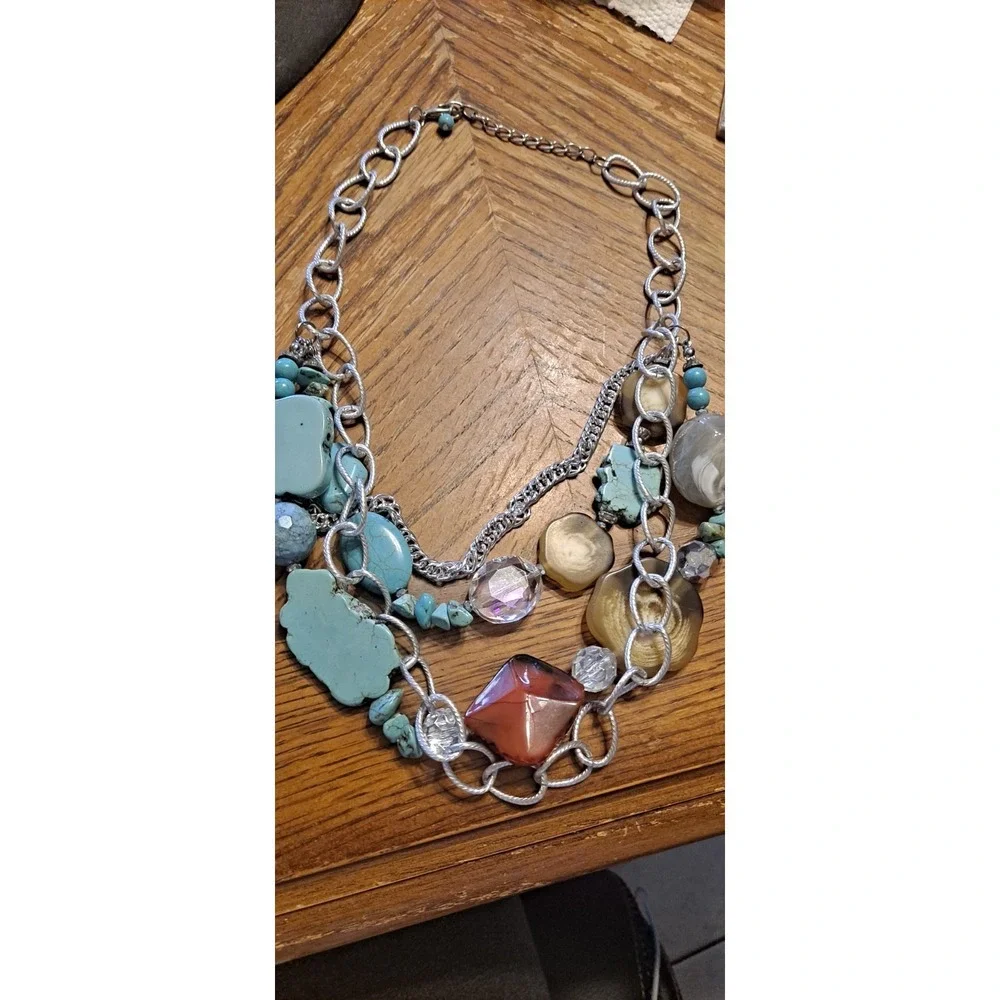 Southwestern-style statement piece featuring multiple strands of silver-toned...